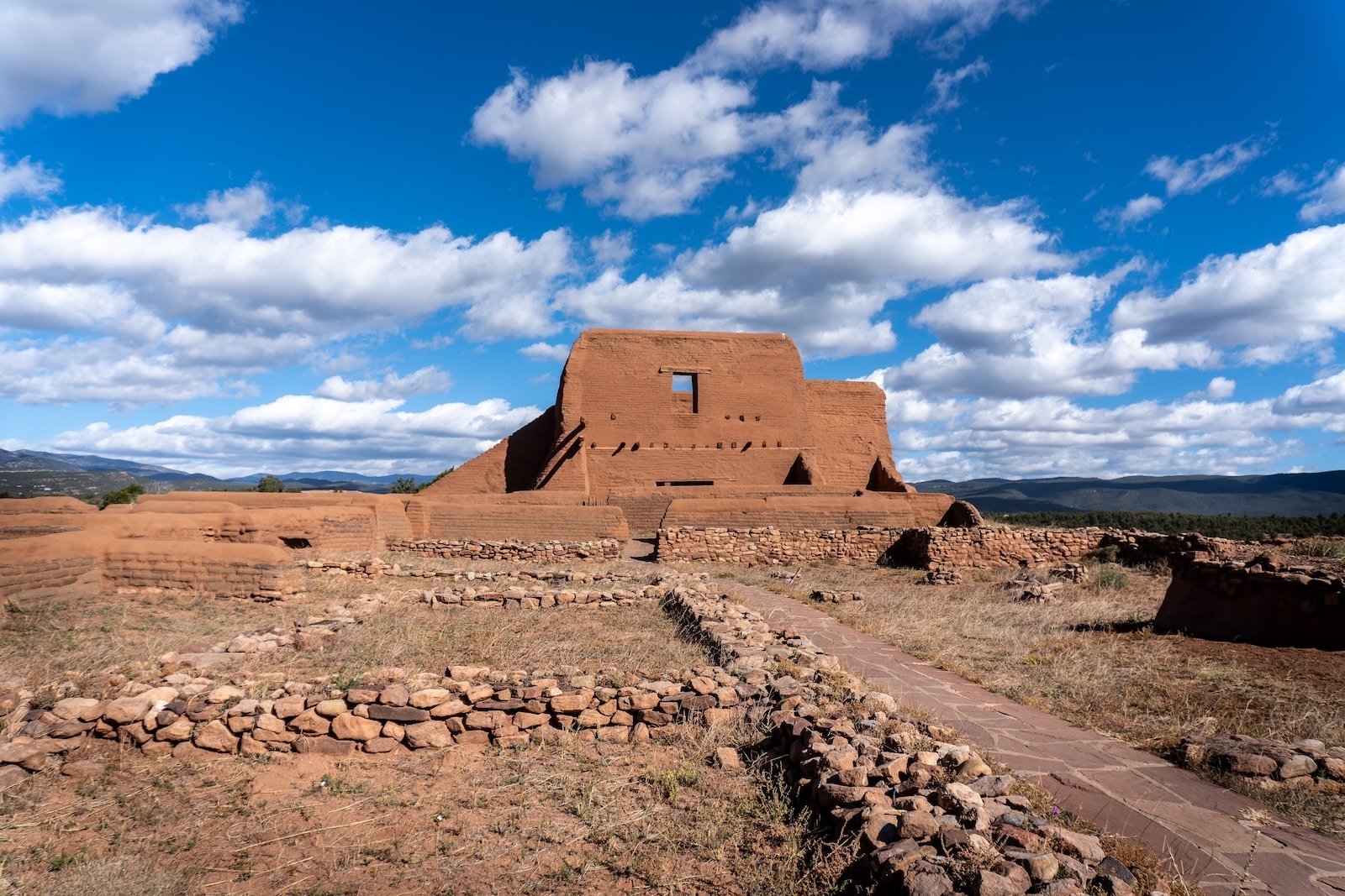 How To Spend Your Day At Pecos National Historical Park 1 Ruins Featuring An Old Structure And Rocks With Clouds And Open Skies At The Pecos National Historical Park In New Mexico.