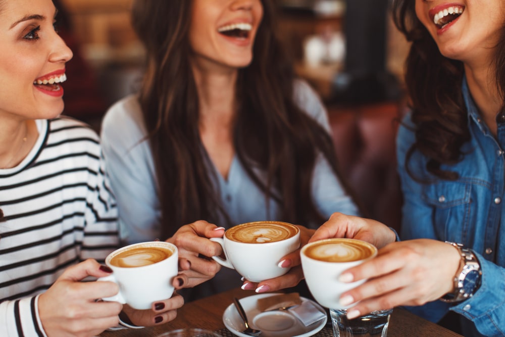 Three Friends Enjoying A Fabulous Cup Of Coffee In Santa Fe While On Their Getaway